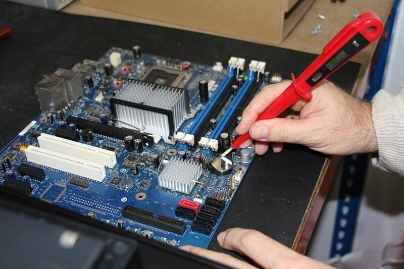 man reparing on the motheboard in computer