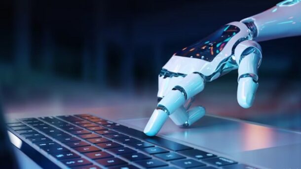 robotic hand pressing keyboard on laptop