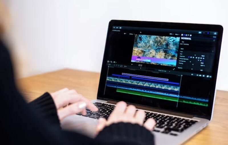 girl editing video on laptop