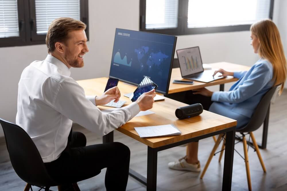 Man looking a Tab and other side sit a woman